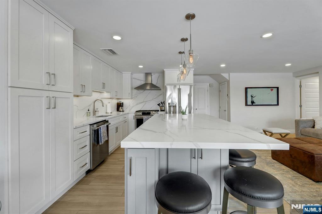 2 Horizon Road, Unit G1 Fort Lee, NJ 07024 - Photo 11 of 44 a kitchen with stainless steel appliances granite countertop a sink a stove a refrigerator cabinets and chairs
