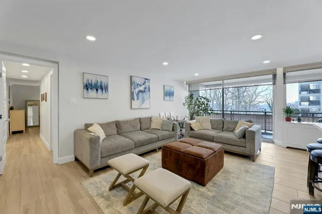 a balcony with wooden floor and glass top table