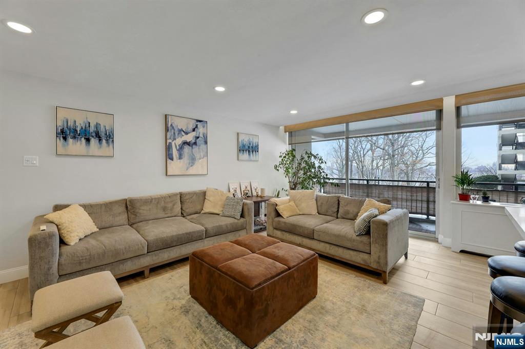 2 Horizon Road, Unit G1 Fort Lee, NJ 07024 - Photo 14 of 44 a living room with furniture and a large window