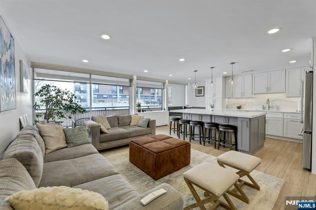 2 Horizon Road, Unit G1 Fort Lee, NJ 07024 - Photo 2 of 44 a living room with furniture and a dining table with kitchen view