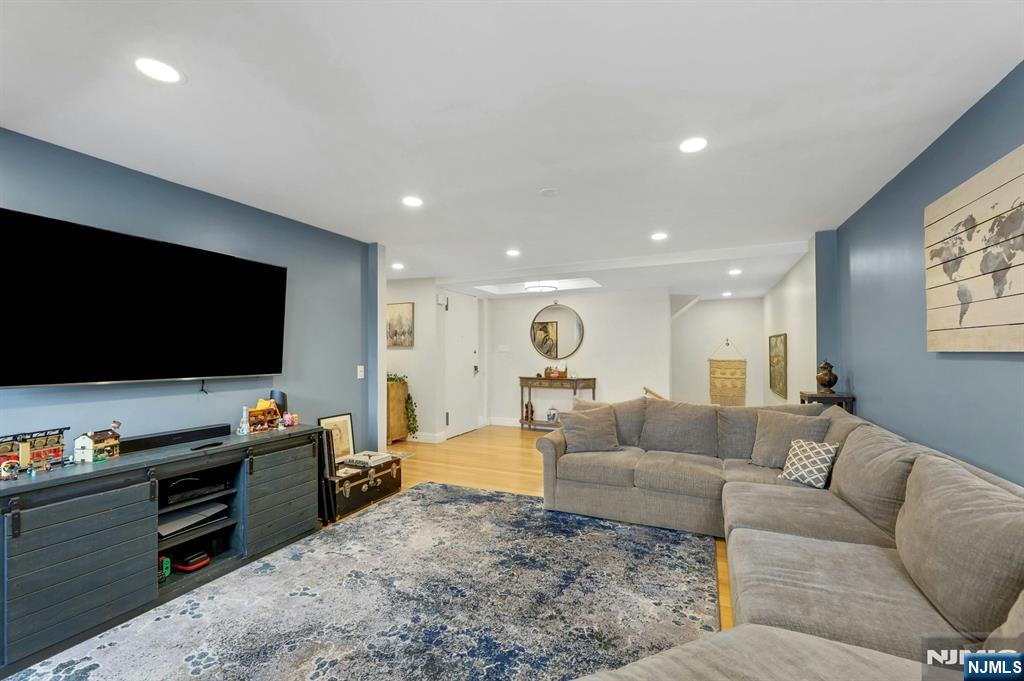 2 Horizon Road, Unit G1 Fort Lee, NJ 07024 - Photo 21 of 44 a living room with furniture and a flat screen tv