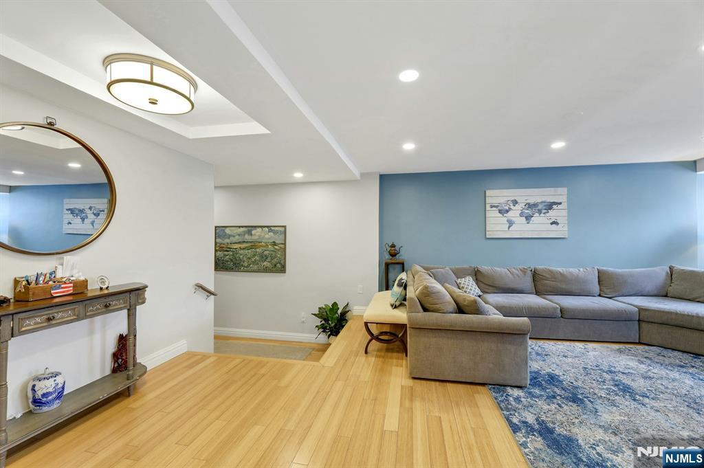 2 Horizon Road, Unit G1 Fort Lee, NJ 07024 - Photo 22 of 44 a living room with furniture and a flat screen tv