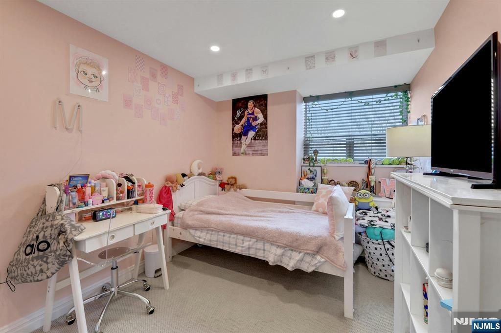 2 Horizon Road, Unit G1 Fort Lee, NJ 07024 - Photo 23 of 44 a bedroom with a bed and a flat screen tv