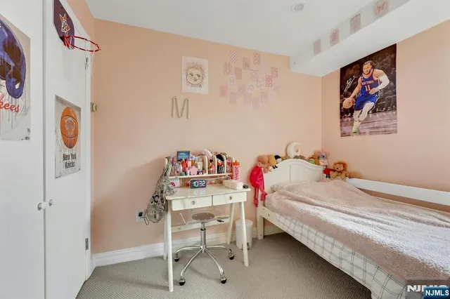 a living room with furniture and a book shelf