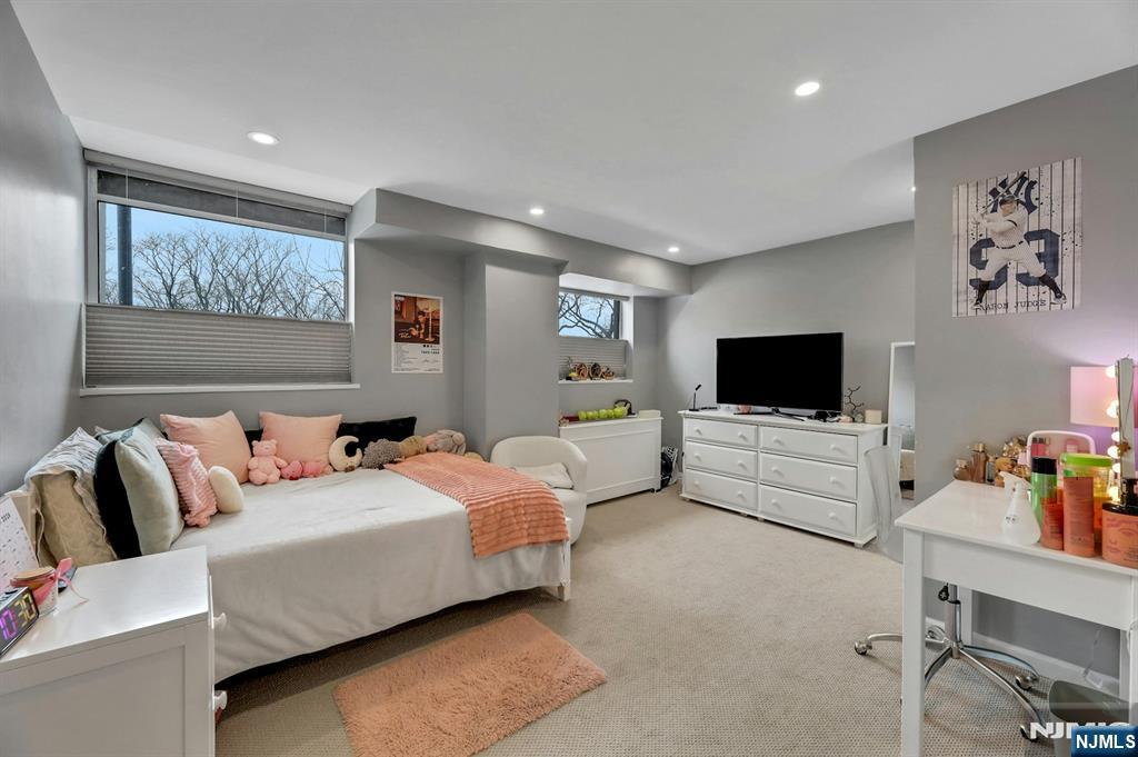 2 Horizon Road, Unit G1 Fort Lee, NJ 07024 - Photo 25 of 44 a bedroom with a bed and a flat screen tv