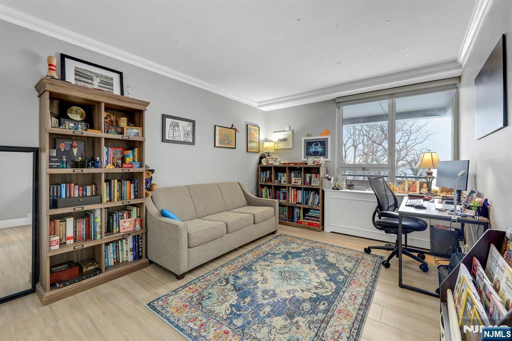 2 Horizon Road, Unit G1 Fort Lee, NJ 07024 - Photo 29 of 44 a living room with furniture and a book shelf