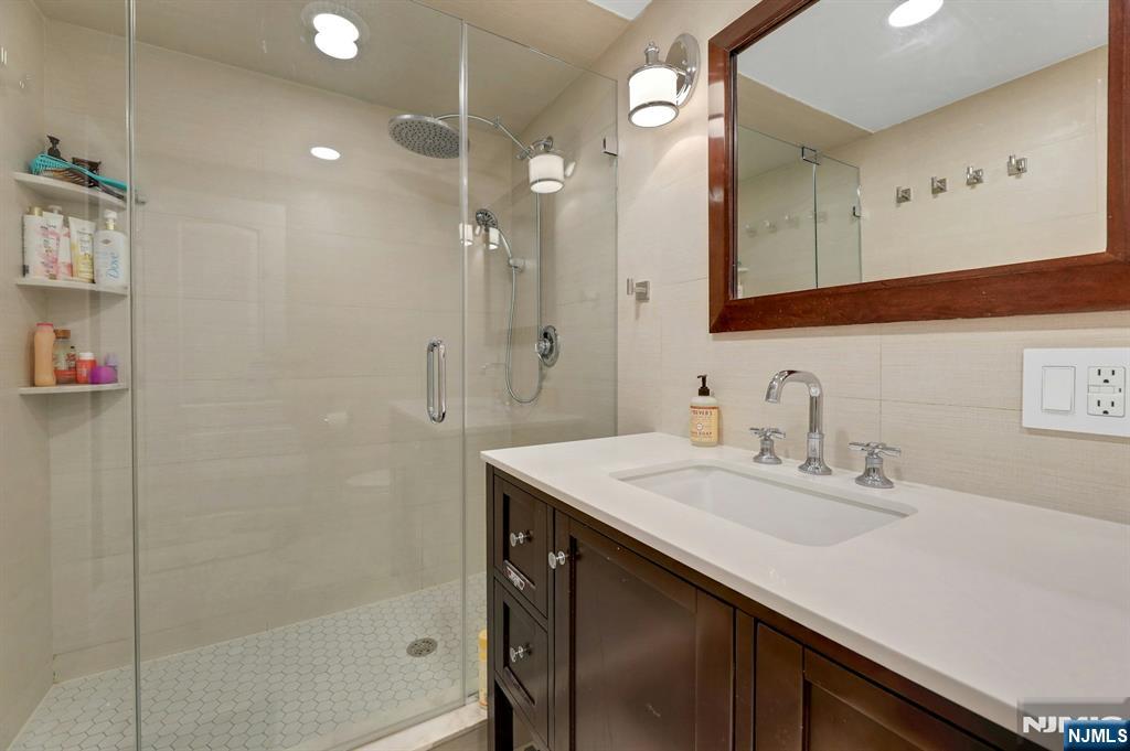 2 Horizon Road, Unit G1 Fort Lee, NJ 07024 - Photo 32 of 44 a bathroom with a sink vanity granite tub and shower