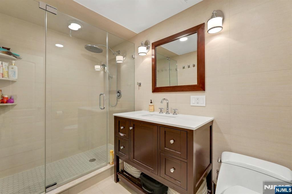 2 Horizon Road, Unit G1 Fort Lee, NJ 07024 - Photo 34 of 44 a bathroom with a sink a toilet and shower