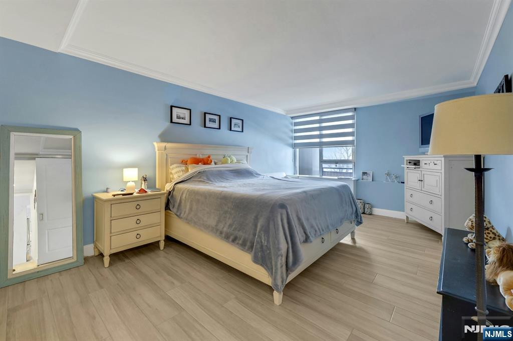 2 Horizon Road, Unit G1 Fort Lee, NJ 07024 - Photo 35 of 44 a bedroom with a bed and a chair in it