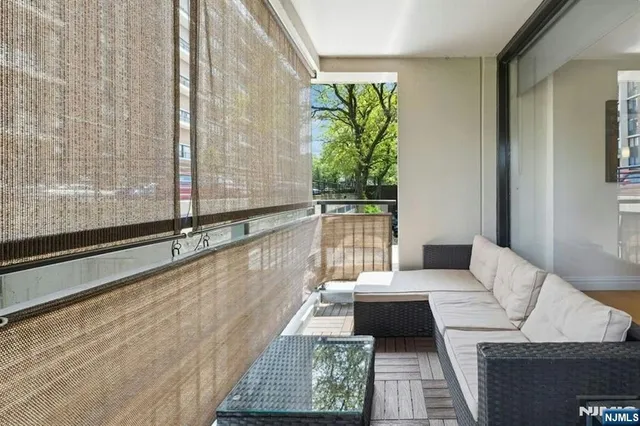 a kitchen with granite countertop a table chairs stove a refrigerator and a living room view