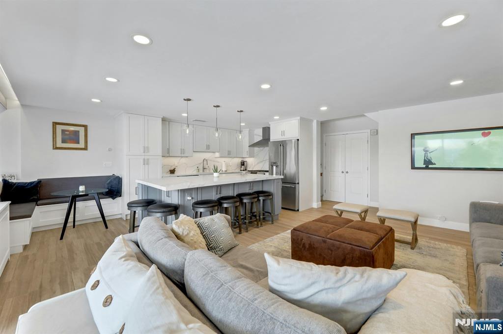2 Horizon Road, Unit G1 Fort Lee, NJ 07024 - Photo 8 of 44 a living room with furniture and a dining table with wooden floor
