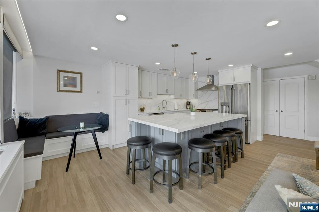 2 Horizon Road, Unit G1 Fort Lee, NJ 07024 - Photo 10 of 44 a kitchen with a dining table chairs and wooden floor