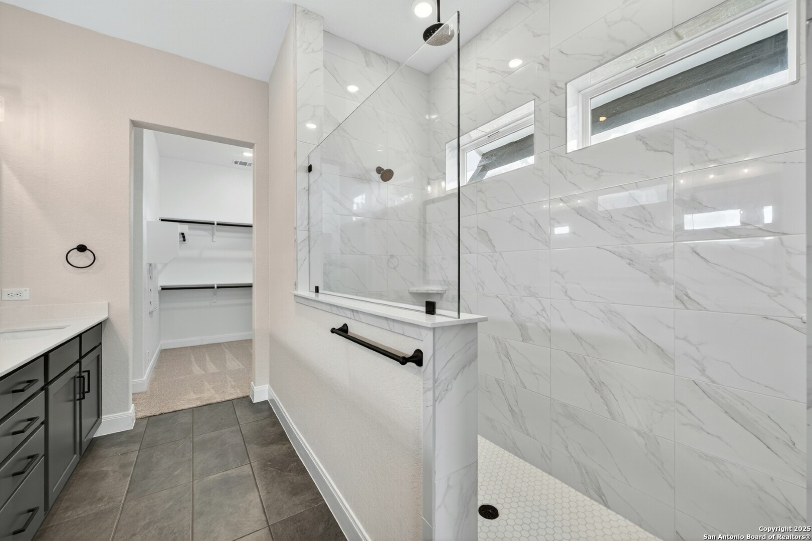 8203 Wellstone Schertz, TX 78154 - Photo 15 of 33 a bathroom with a glass shower door and a sink