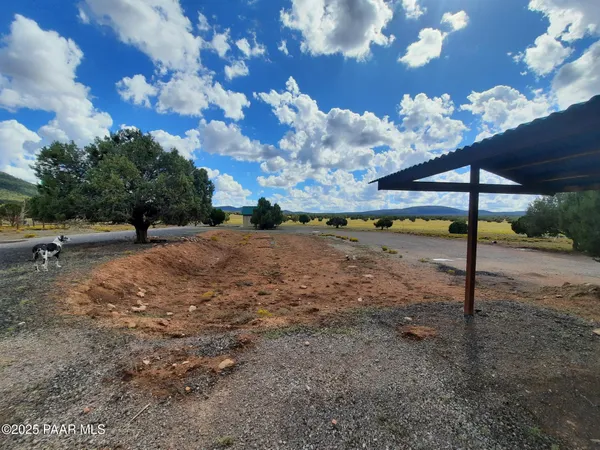 a view of dirt road with a building in the background