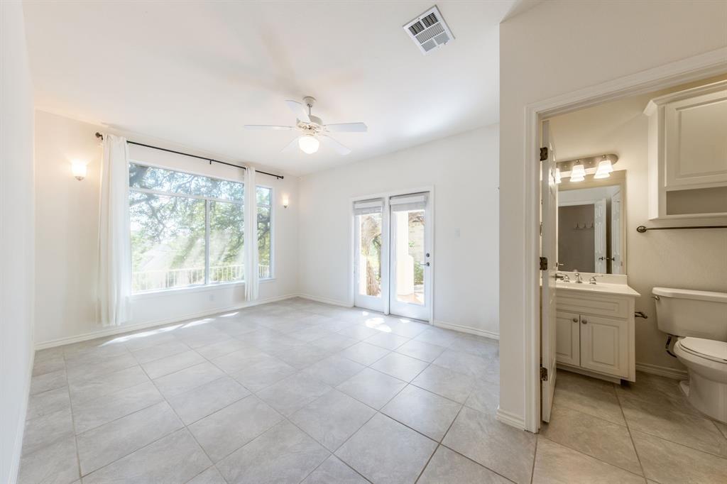 1704 Randolph Ridge Trail Austin, TX 78746 - Photo 13 of 23 Downstairs bedroom with an ensuite bathroom and door to the exterior could be used as an office too