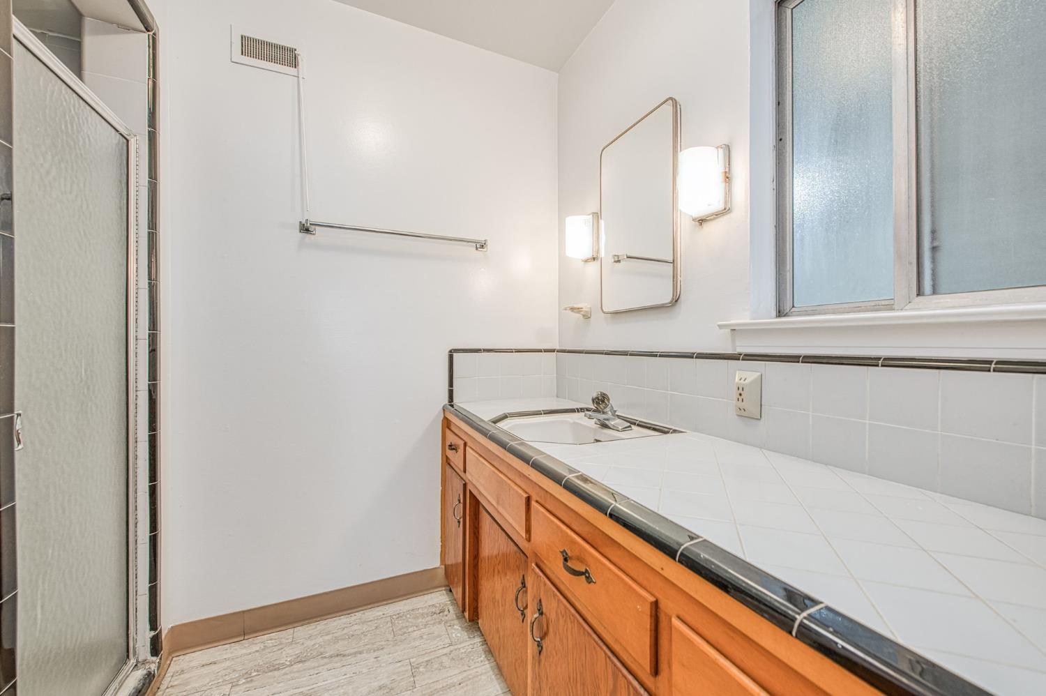 13130 South Henderson Road Caruthers, CA 93609 - Photo 14 of 36 a bathroom with a sink and a mirror