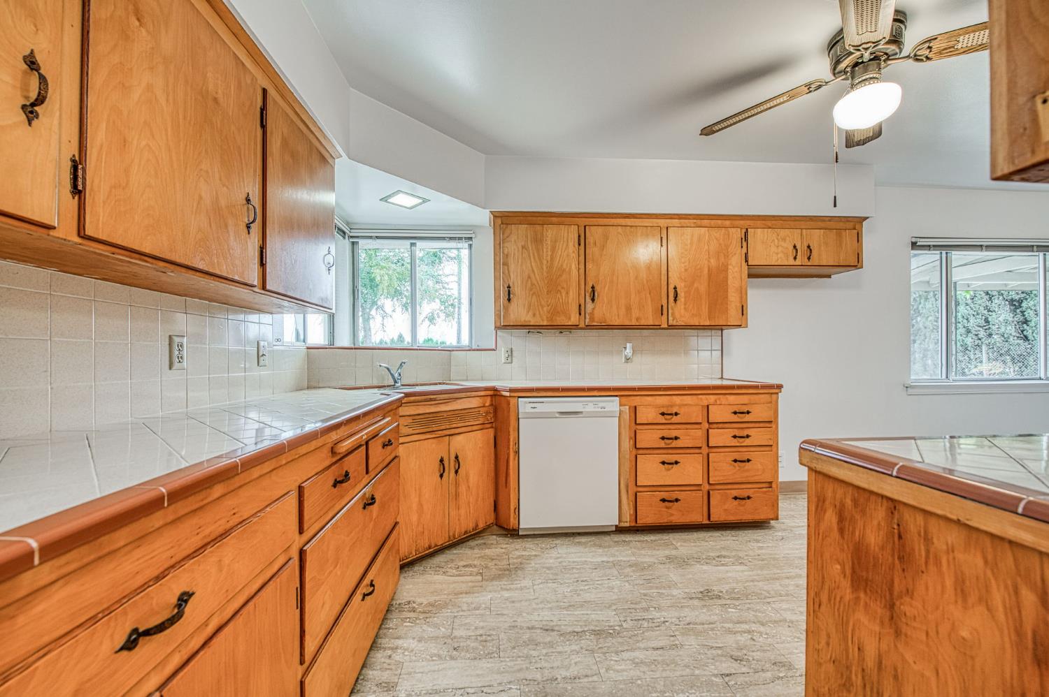 13130 South Henderson Road Caruthers, CA 93609 - Photo 6 of 36 a large kitchen with stainless steel appliances granite countertop a sink and cabinets