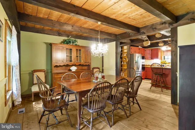a kitchen with stainless steel appliances granite countertop a sink a stove and a wooden floors
