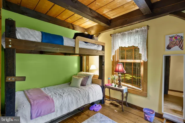 a aerial view of a house with a yard balcony and mountain view