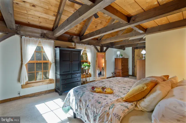 a bedroom with furniture and a window