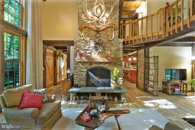 a living room with furniture and a floor to ceiling window