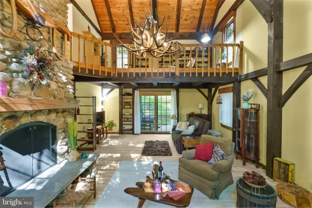 a living room with furniture a fireplace and a table