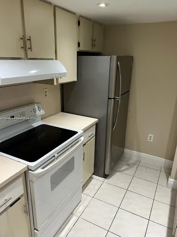 a kitchen with a stove and a refrigerator