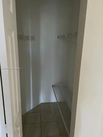 a view of an empty room and a window