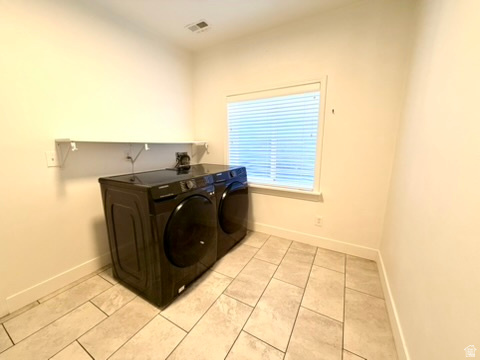 11895 Inauguration Road Draper, UT 84020 - Photo 13 of 13 Laundry area featuring tile flooring, a window with blinds, and a wall-mounted shelf