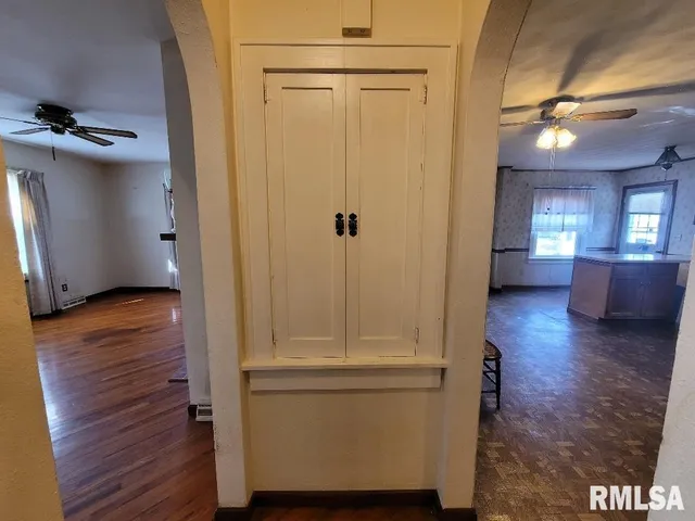 a view of a hallway with wooden floor