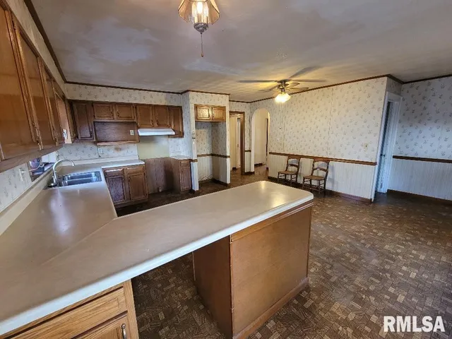 a kitchen with stainless steel appliances granite countertop a sink a stove and a refrigerator