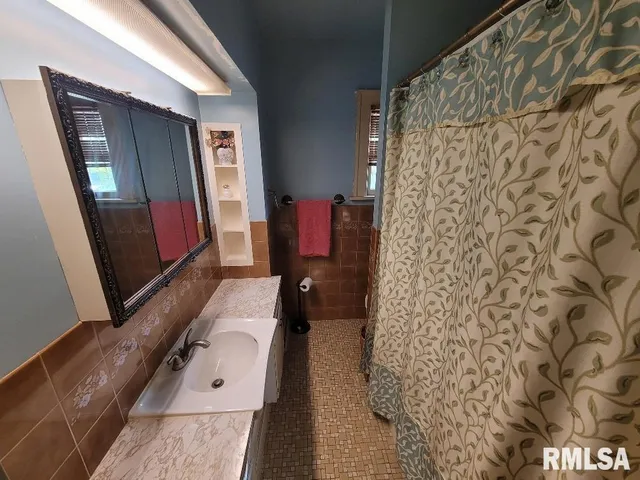 a bathroom with a bathtub and shower