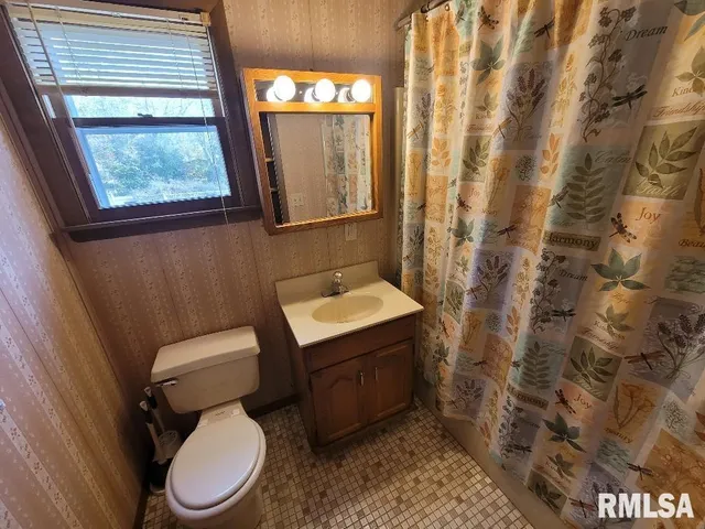a white toilet sitting next to a bathroom sink