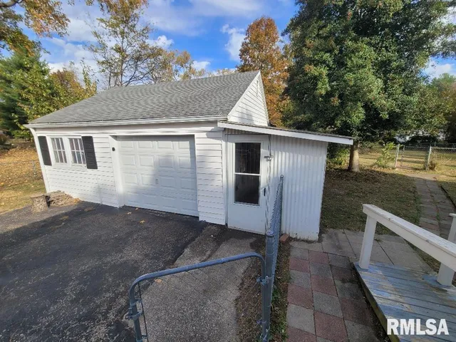a front view of a house with a garden and yard