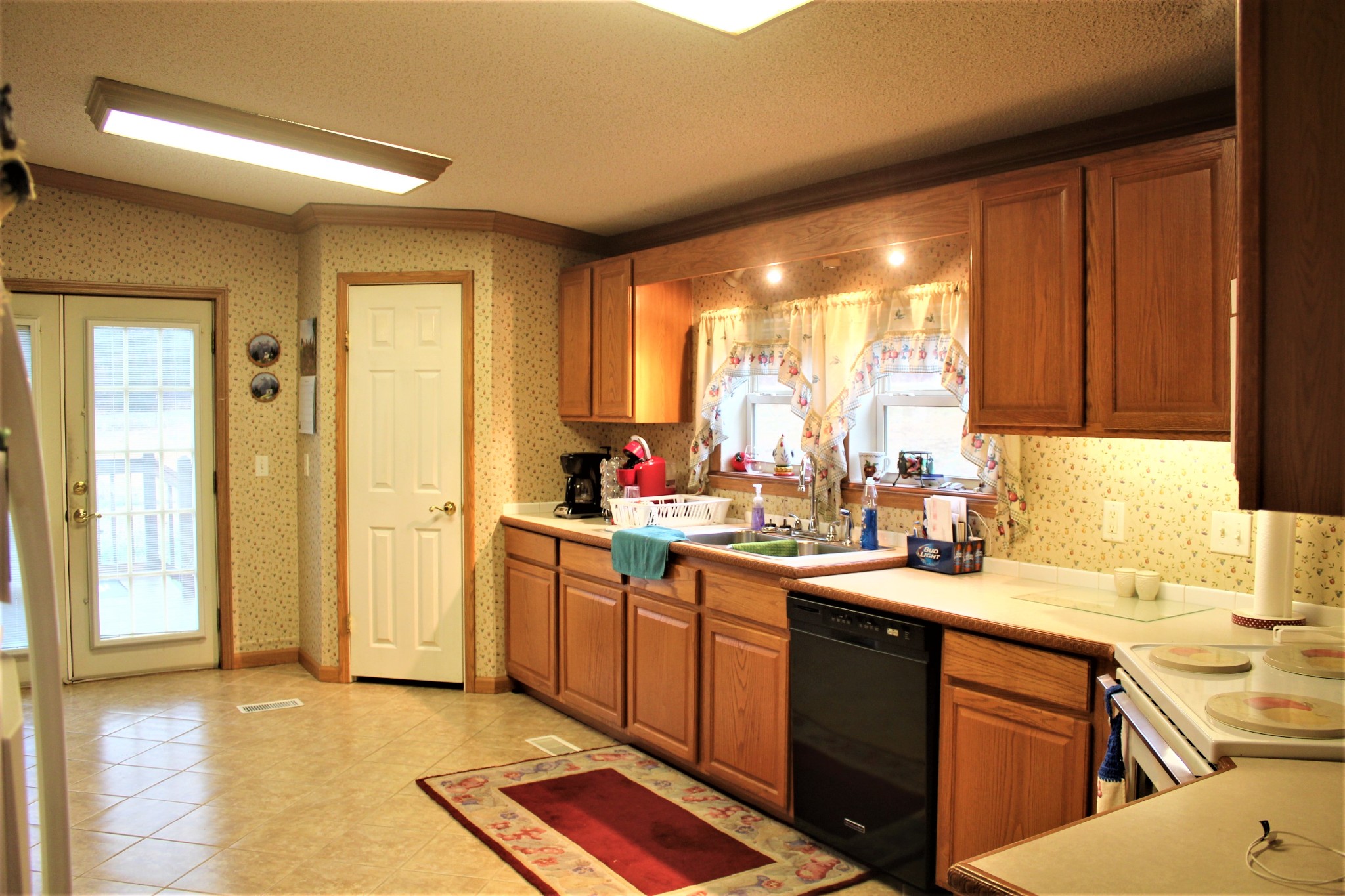 8154 Pinewood Road Nunnelly, TN 37137 - Photo 22 of 41 a kitchen with a sink stove and cabinets