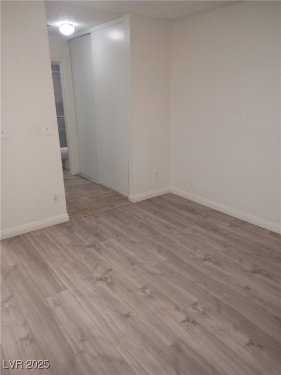 4830 Nara Vista Way, Unit 103 Las Vegas, NV 89103 - Photo 11 of 20 Basement with light wood-type flooring and baseboards