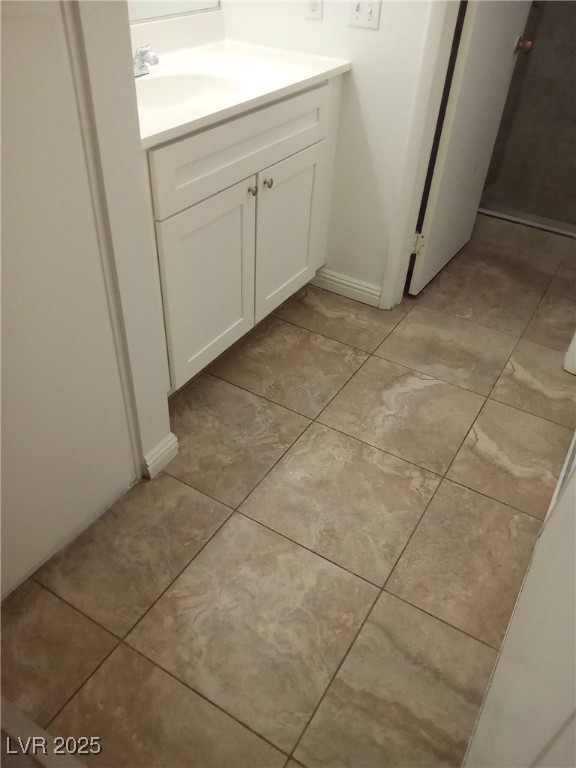 4830 Nara Vista Way, Unit 103 Las Vegas, NV 89103 - Photo 13 of 20 Bathroom featuring vanity and light tile patterned flooring