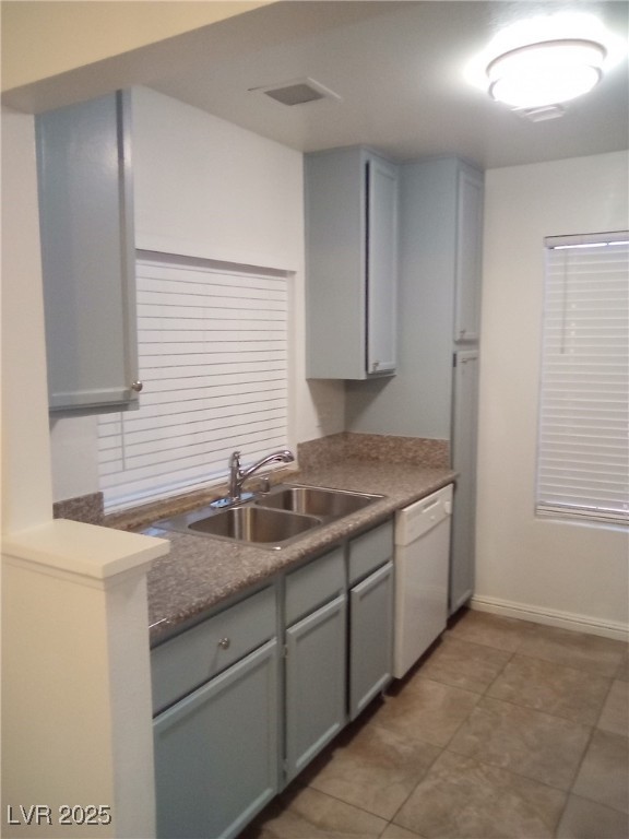 4830 Nara Vista Way, Unit 103 Las Vegas, NV 89103 - Photo 6 of 20 Kitchen featuring gray cabinets, dark countertops, white dishwasher, and dark tile patterned flooring