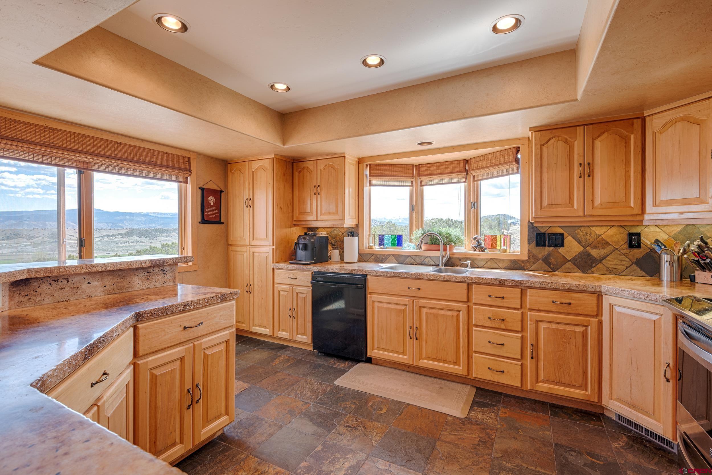 20891 Solitude Road Montrose, CO 81403 - Photo 11 of 39 a kitchen that has a sink and a stove in it