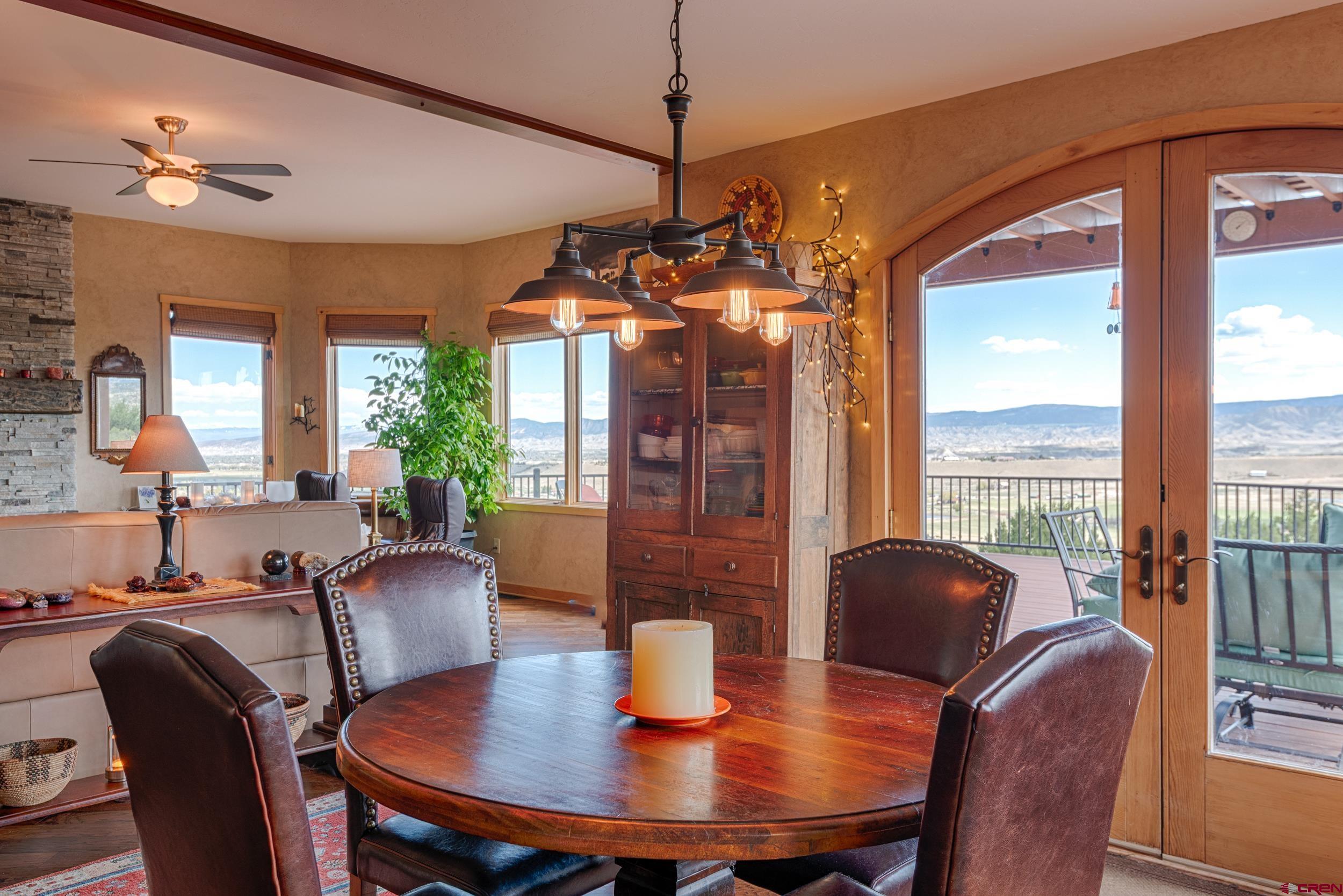 20891 Solitude Road Montrose, CO 81403 - Photo 13 of 39 a view of a dining room with furniture window and outside view