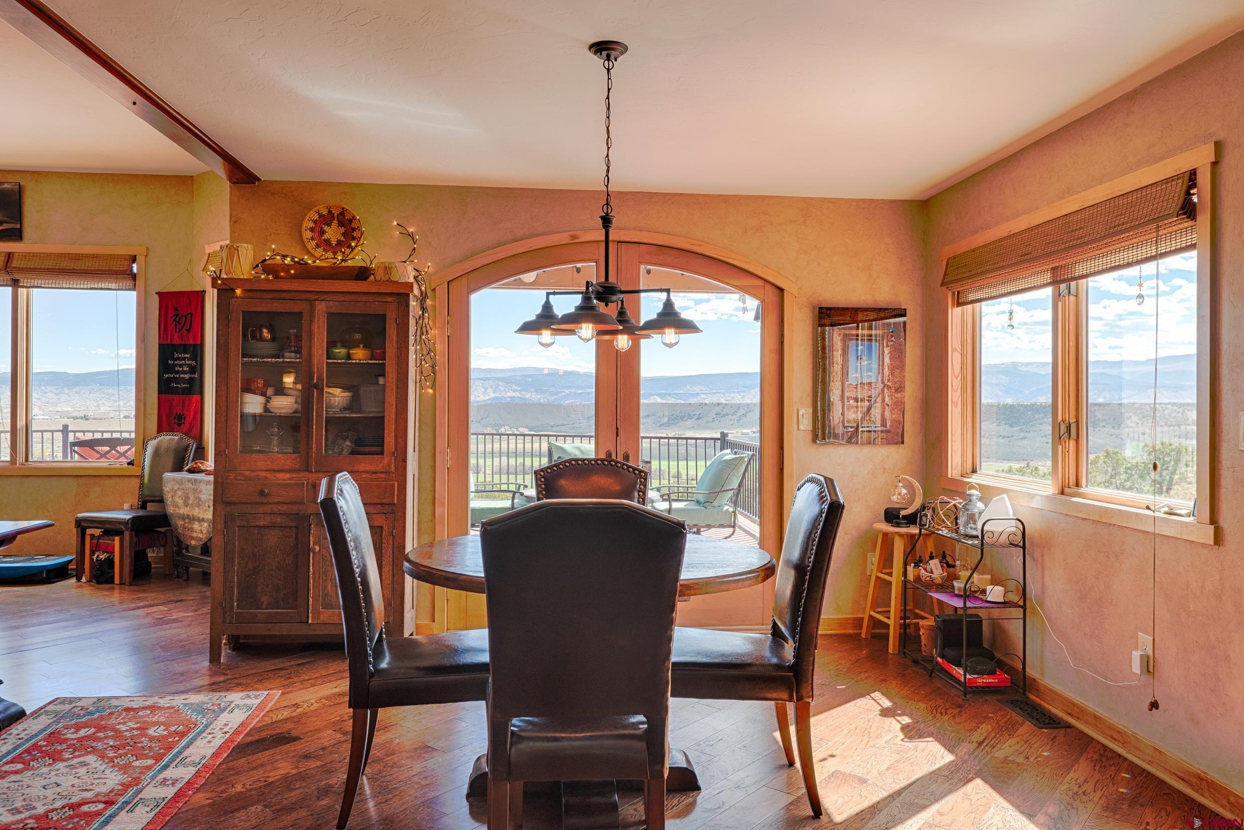 20891 Solitude Road Montrose, CO 81403 - Photo 14 of 39 a view of a dining room with furniture window and wooden floor