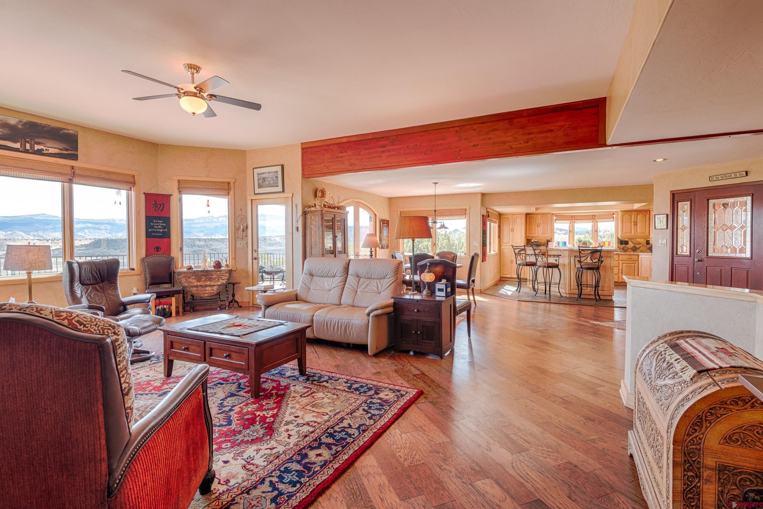 20891 Solitude Road Montrose, CO 81403 - Photo 15 of 39 a living room with furniture and a large window