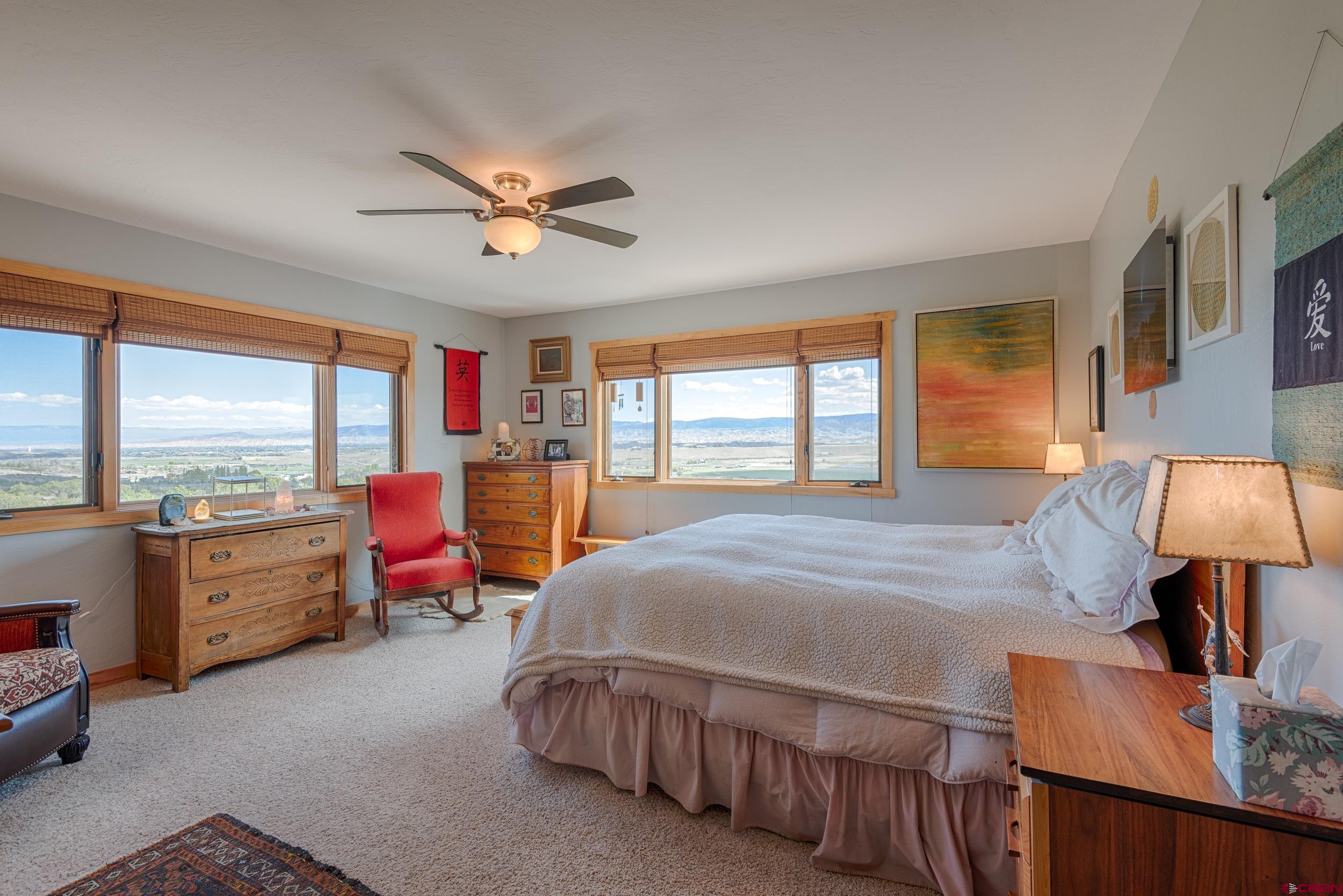 20891 Solitude Road Montrose, CO 81403 - Photo 17 of 39 a bedroom with furniture and a large window