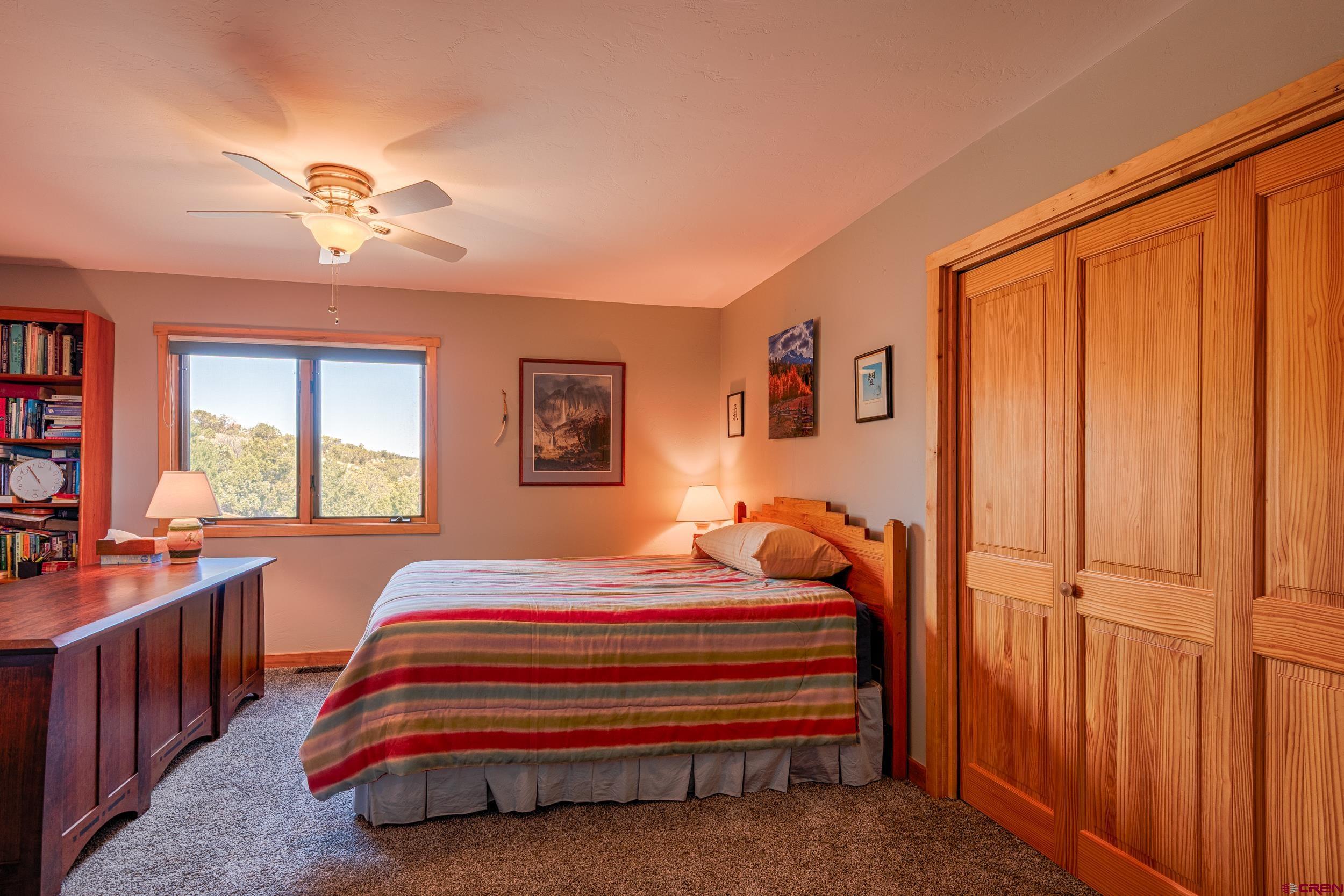 20891 Solitude Road Montrose, CO 81403 - Photo 21 of 39 a bedroom with bed and a window