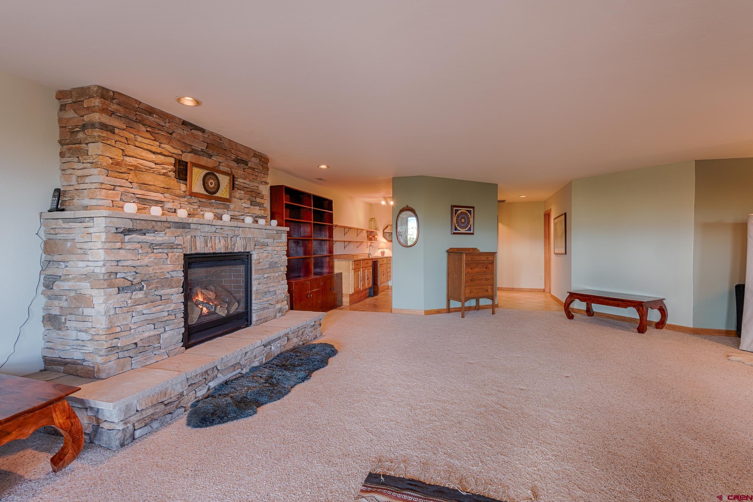 20891 Solitude Road Montrose, CO 81403 - Photo 25 of 39 a living room with furniture and a fireplace