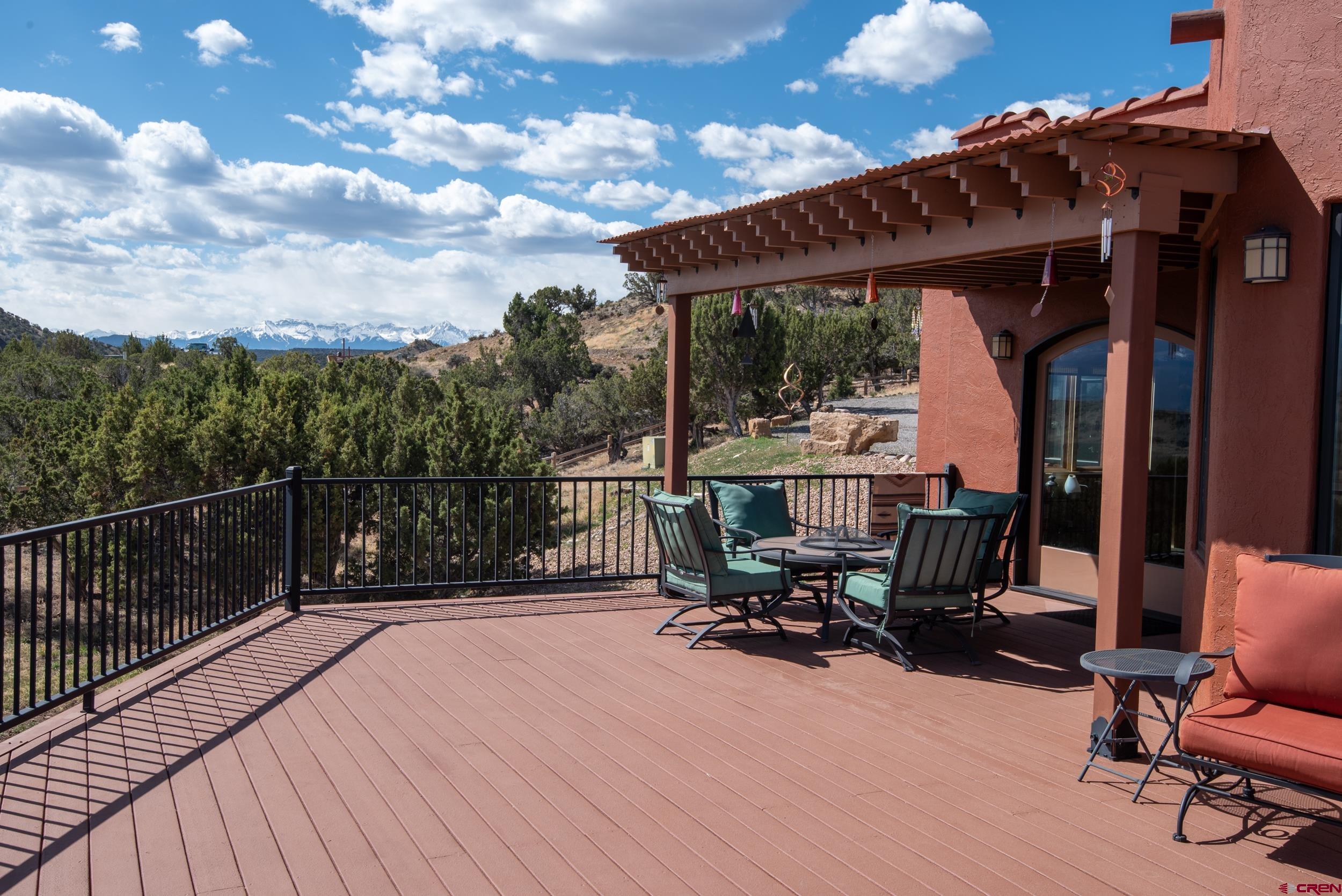 20891 Solitude Road Montrose, CO 81403 - Photo 33 of 39 a view of balcony with chairs and wooden fence