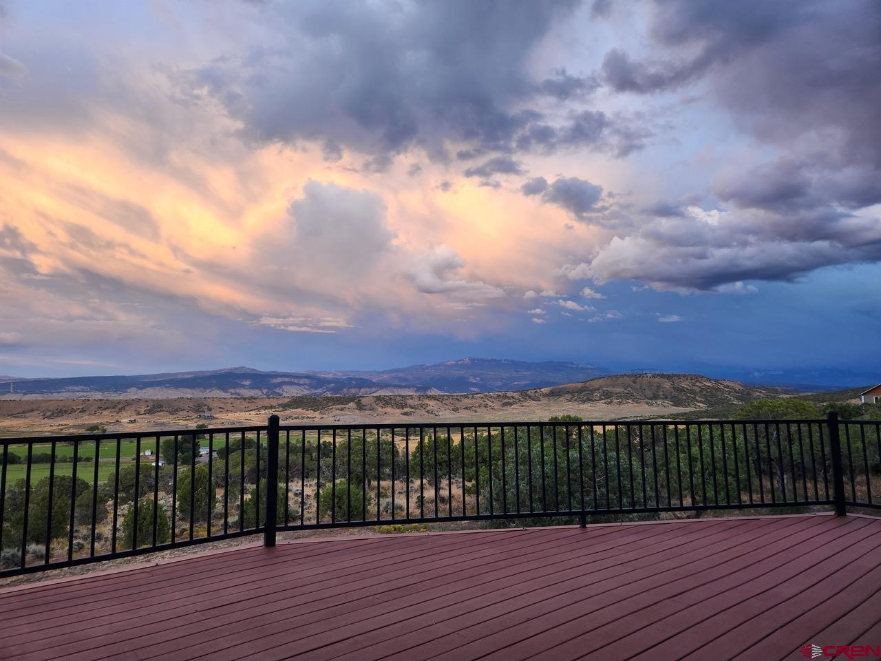 20891 Solitude Road Montrose, CO 81403 - Photo 37 of 39 a view of a balcony with wooden floor and city view