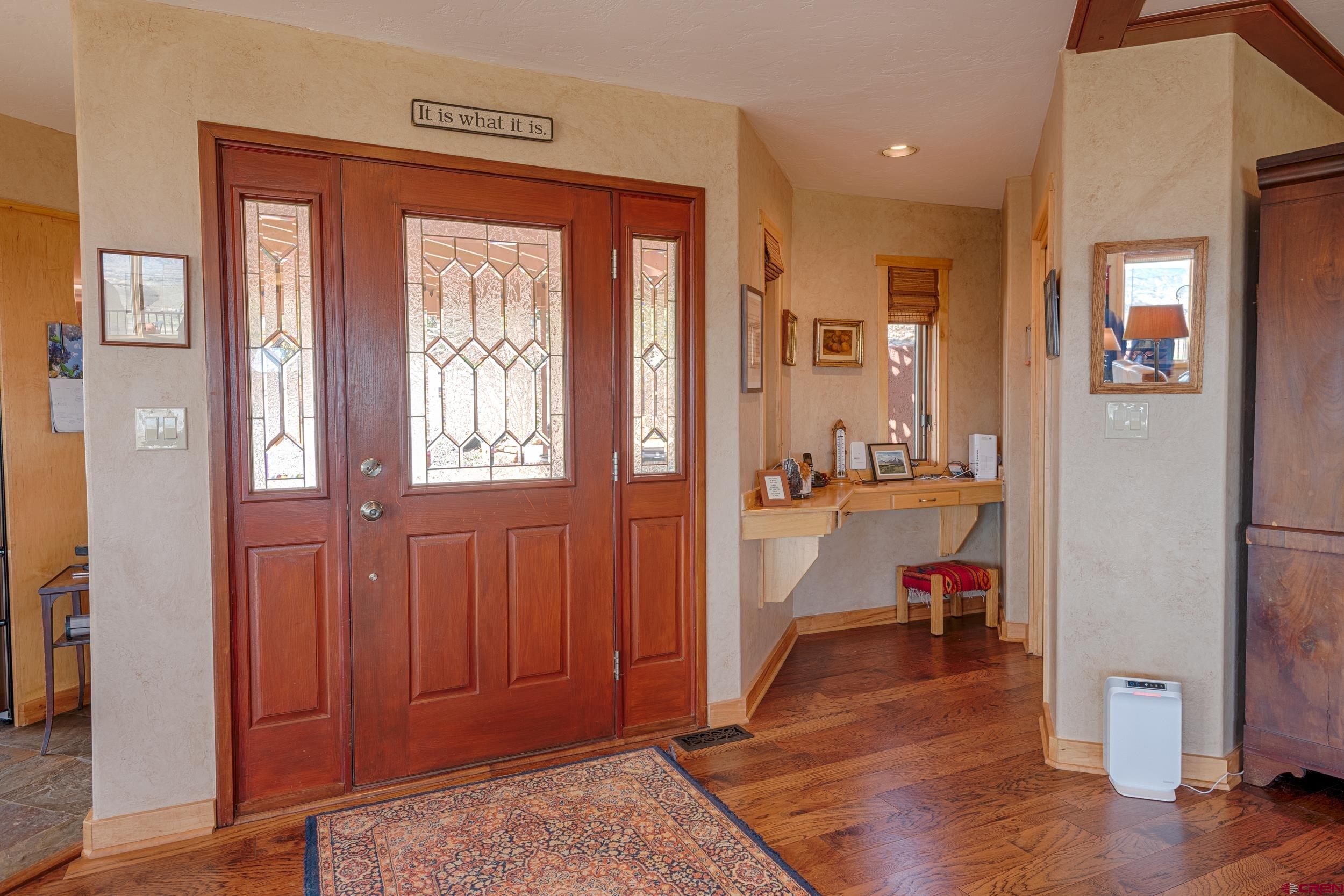 20891 Solitude Road Montrose, CO 81403 - Photo 4 of 39 view of hall way with mirror and furniture