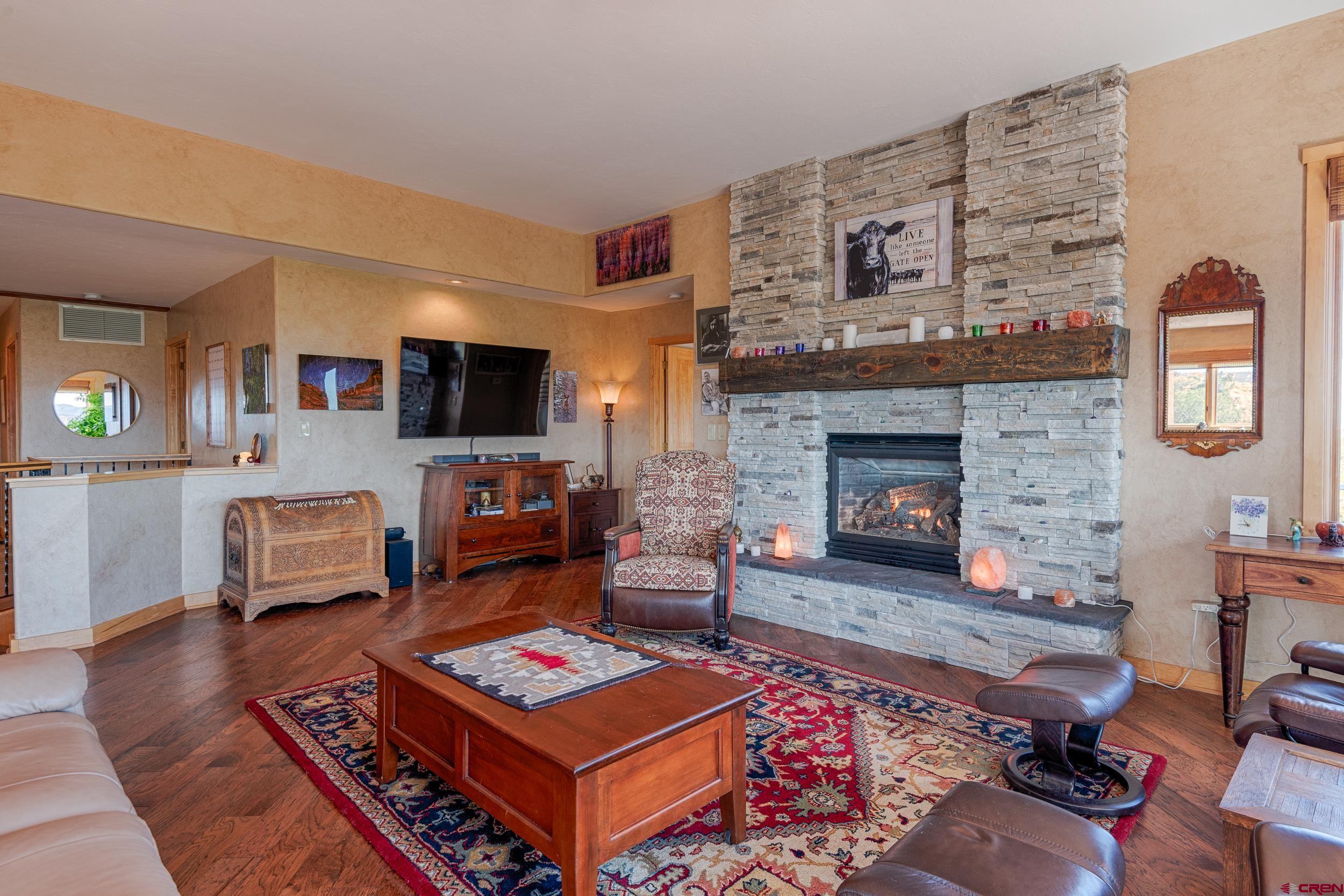 20891 Solitude Road Montrose, CO 81403 - Photo 6 of 39 a living room with furniture and a fireplace