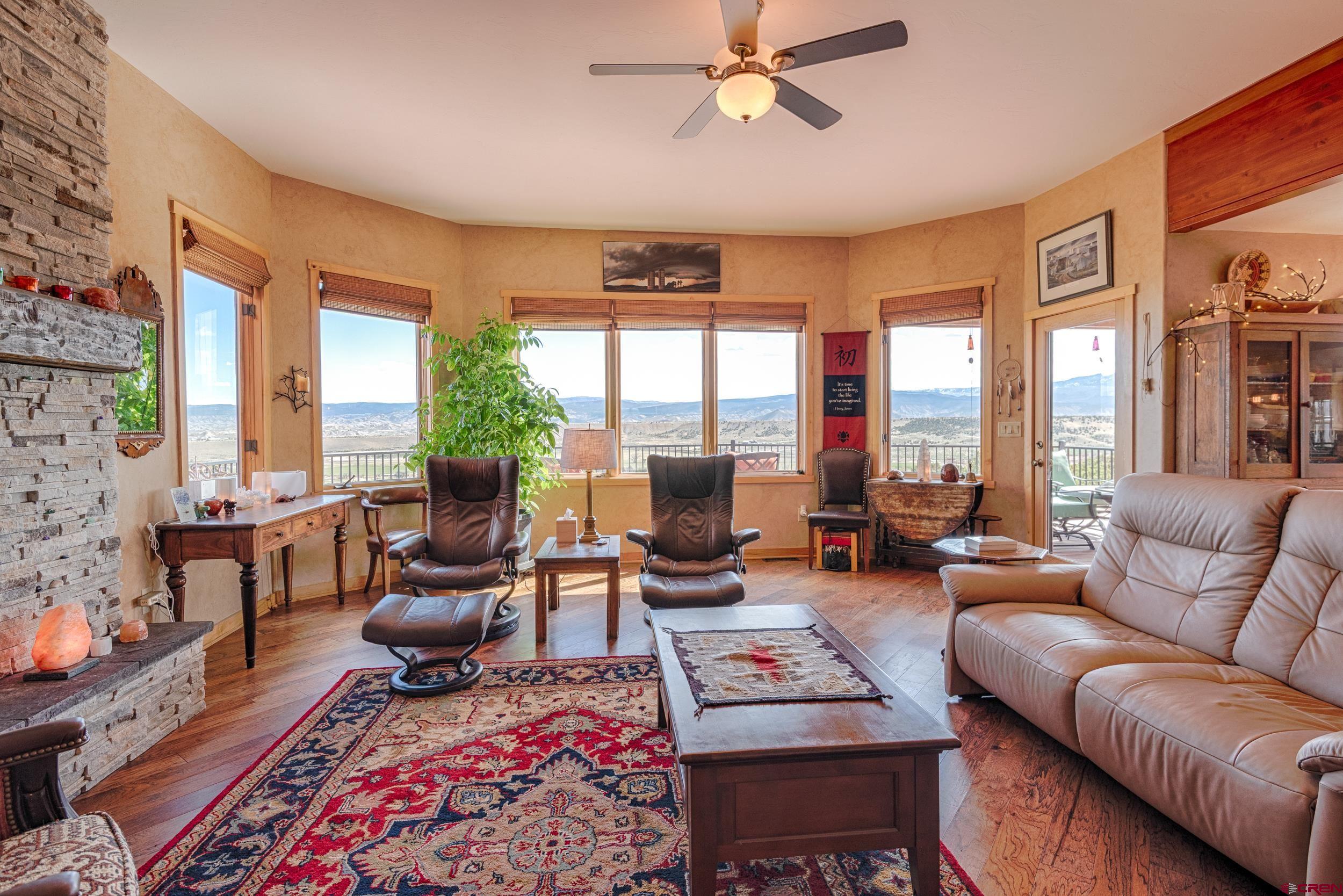 20891 Solitude Road Montrose, CO 81403 - Photo 7 of 39 a living room with furniture and a floor to ceiling window